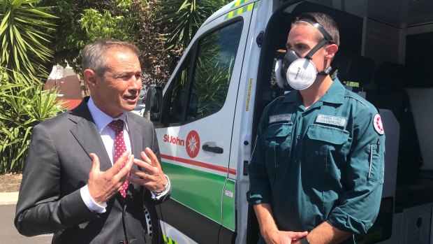 WA Health Minister Roger Cook with a St John paramedic wearing one of the new masks