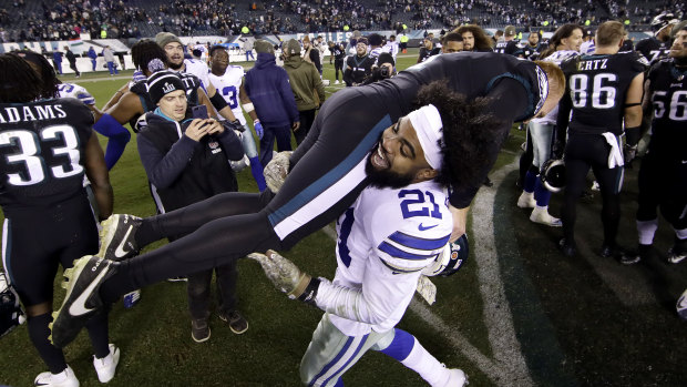 Cameron Johnston, who is also vying for a Pro Bowl spot, is carried by Dallas' Ezekiel Elliott.