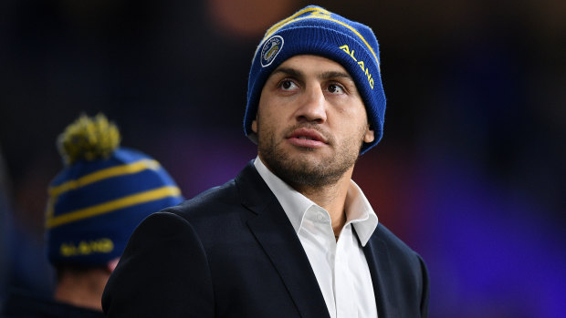 Keen spectator: Blake Ferguson watches on from the sideline during the Eels' clash with the Knights at Bankwest Stadium.