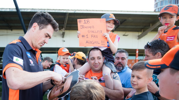 Jeremy Cameron signs autographs for fans at the Giants' family fun day on Sunday.