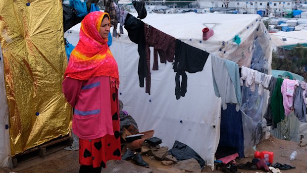 A migrant stands next to their makeshift tent outside the perimeter of the overcrowded Moria refugee camp on the north-eastern Aegean island of Lesbos, Greece.