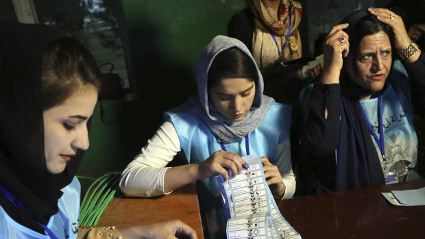Afghan election workers count ballots during the presidential elections, at a polling station in Kabul.