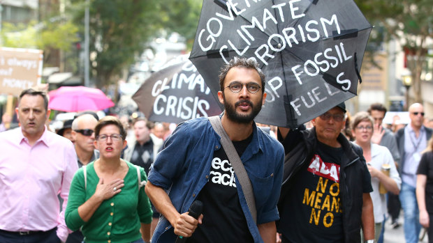 Greens Councillor Jonathan Sri leads people through city streets in August 2018 after the state government announced tougher police search powers against protesters.