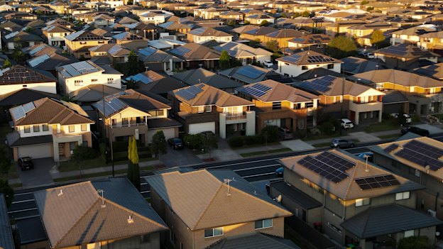 A development in Marsden Park with dark roofs and minimal trees and black roads and driveways where temperatures will be high in summer and there will be a reliance on air conditioners in Western Sydney.