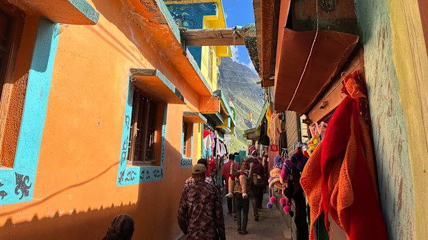 A pilgrim is carried through Mana village.