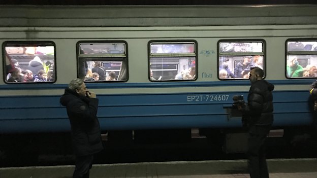 Nik Millard (right) captures a platform farewell in Lviv, Ukraine.
