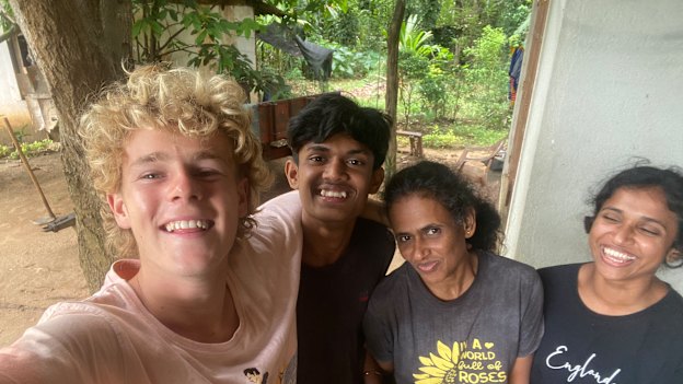 Charlie Stowe with the host family he stayed with in Sri Lanka while working on a farm.