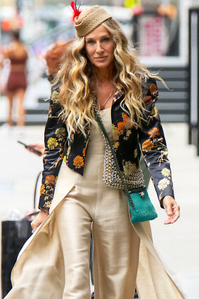 Sarah Jessica Parker as Carrie Bradshaw wearing, a vintage Claude Montana jumpsuit and Dries Van Noten jacket  while filming “And Just Like That.”