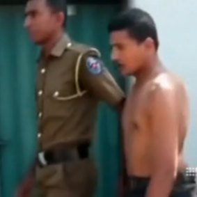 A suspect being arrested in Colombo.