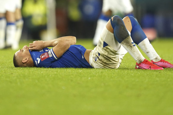 Everton’s Richarlison lies on the pitch after his team’s lost.