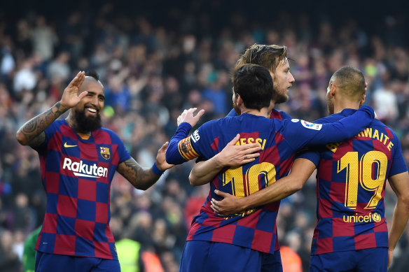 Lionel Messi, celebrating a goal with teammates in February, is among Barcelona players taking a pay cut during the shutdown.