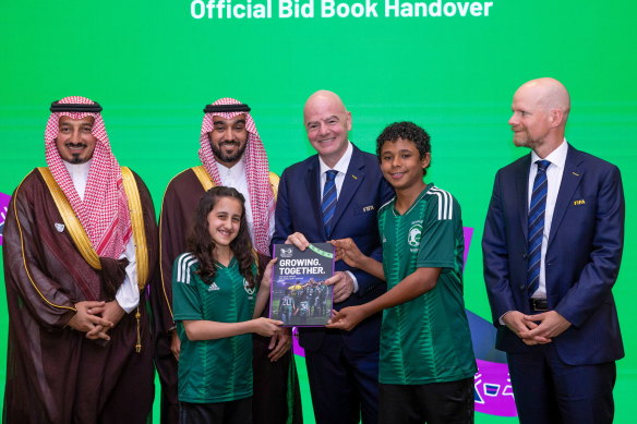 Gianni Infantino and FIFA secretary general Mattias Grafström receive the official 2034 bid book from Saudi Arabian Football Federation president Yasser Al Misehal, Saudi Arabia Minster for Sport HRH Prince Abdulaziz bin Turki Al-Faisal and two young Saudi Arabian fans.