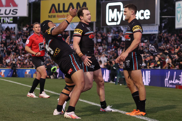 Nathan Cleary (right) celebrates after his late try.