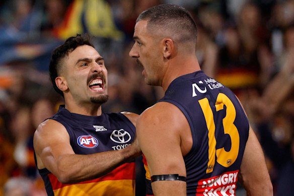 Izak Rankine and Taylor Walker celebrate a big Adelaide goal.