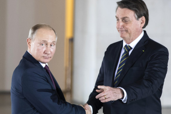 Brazilian President Jair Bolsonaro, right, welcomes Russian President Vladimir Putin to a meeting of leaders of the BRICS countries in Brasilia in 2019.