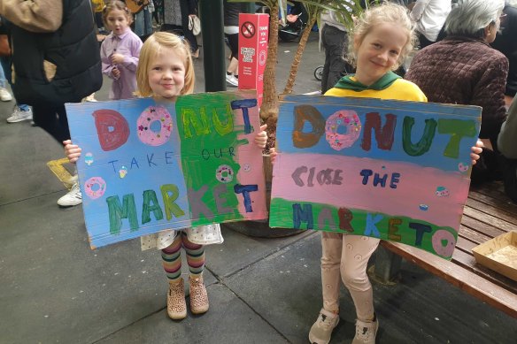 Amelia, 4, and Violet Spence, 6, show their support at the Save Preston Market Day.