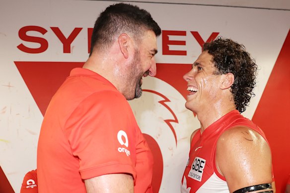 Swans coach Dean Cox and spearhead Charlie Curnow share a laugh after the game.