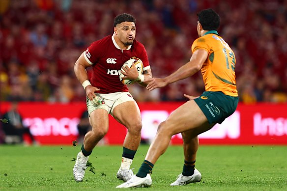 Sione Tuipulotu takes a carry with Joseph Aukuso-Suaalii in defence.