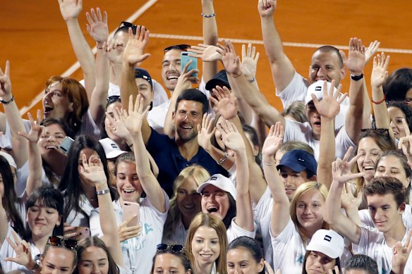 Serbia's Novak Djokovic, centre, poses with volunteers and players after the infamous Adria Tour tournament in Belgrade on June 14.