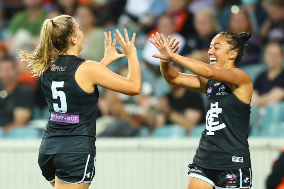 Abbie McKay celebrates her goal with Carlton teammate Darcy Vescio.