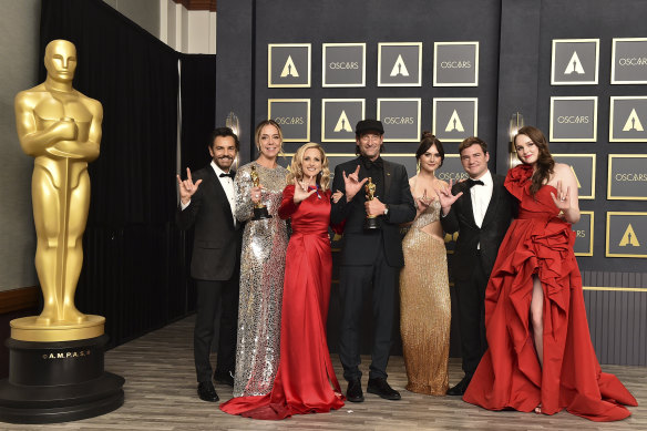 From left: Eugenio Derbez, Sian Heder, Marlee Matlin, Troy Kotsur, Emilia Jones, Daniel Durant and Amy Forsyth, winners of the award for best picture for CODA, pose in the press room while signing “I love you”.