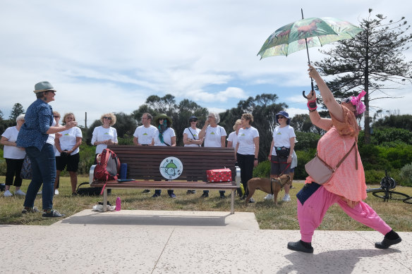 Passerby Samantha Taplin dancing as the Elwood Community Choir sings from the Elwood Singing Walking Trail in 2022.