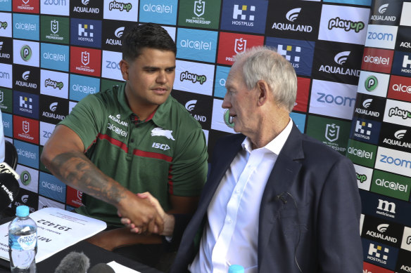 New recruit Latrell Mitchell shakes hands with Souths coach Wayne Bennett on Monday.
