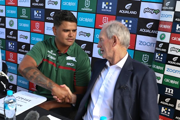 New recruit Latrell Mitchell shakes hands with Souths coach Wayne Bennett on Monday.
