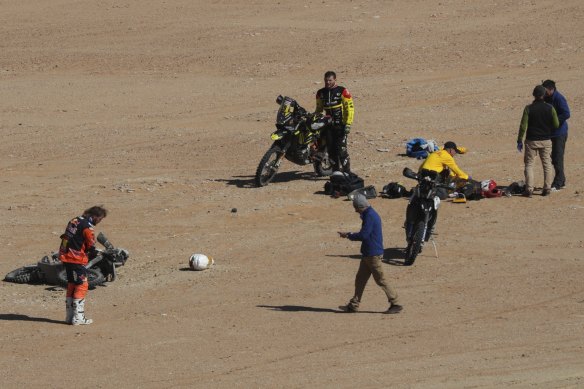 Australian Toby Price (left) at the scene of the Dakar Rally crash which claimed the life of fellow motorbike rider Paulo Goncalves.