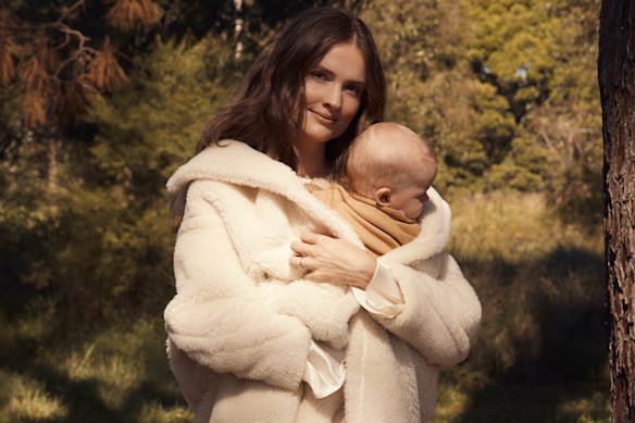 Laura Henshaw, with baby Atlas. Laura wears Max Mara coat. Zara dress and boots. Atlas wears Nature Baby (throughout).