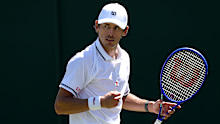 Alex de Minaur celebrates winning a point.