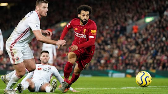 Sheffield United's Jack O'Connell (left) and Liverpool's Mohamed Salah dash for the ball.