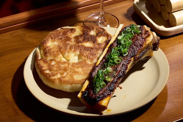Wood-fired bone marrow with crab sambal and flaky coconut roti at Tyga.