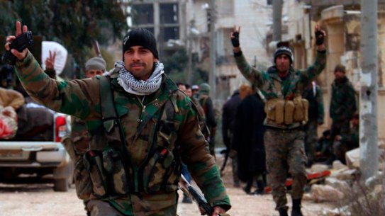 Syrian army soldiers flash the victory sign in the Rashideen neighbourhood, in Aleppo province, Syria, on February 16.