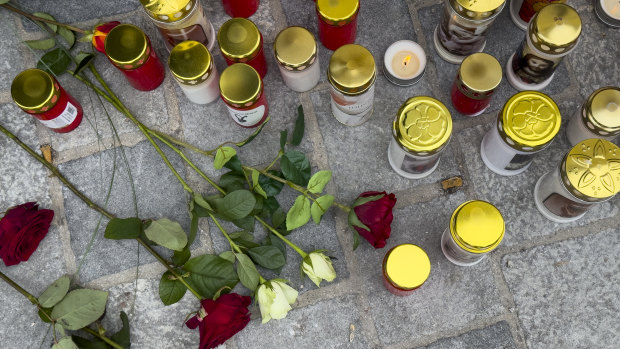 Candles and flowers are placed at the site of stabbing a day after an attack that left a 14-year-old dead and five others injured.