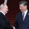 Russian President Vladimir Putin, left, and Chinese President Xi Jinping shake hands in Beijing. 