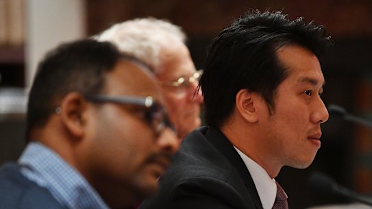 Alton Chen, right,, with other apartment owners from Mascot Towers at the inquiry.