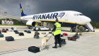 Belarusian security checks luggage on the grounded Ryanair flight in Minsk on Sunday.