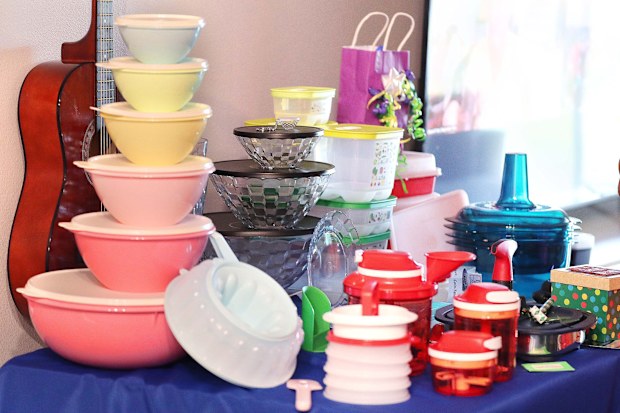 Tupperware items, including a set of "retro" storage containers at left, rest on a table during a Tupperware party in Sebastian, Florida, on May 18, 2022. (Stephen M. Dowell/Orlando Sentinel/Tribune News Service via Getty Images)
