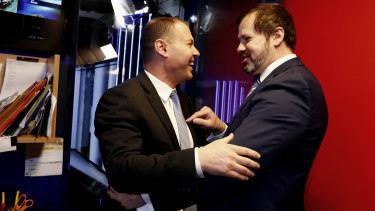 Environment and Energy Minister Josh Frydenberg crosses paths with Labor MP Ed Husic outside the Sky News studio at Parliament House in Canberra in 2017.