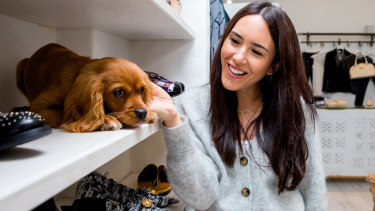 Jenna Isaacman with her 4-month-old cavoodle, Teddy, at her business 'Trading in Style' in Randwick. 
