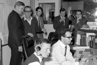 Prime minister John Gorton (left) visits the Honeysuckle Creek Tracking Station on the morning of July 21, 1969. 
Seated is John Saxon and Ian Grant. Next to Gorton is station director Tom Reid. 