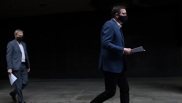 Premier Daniel Andrews leads Chief Health Officer Brett Sutton into the daily briefing.