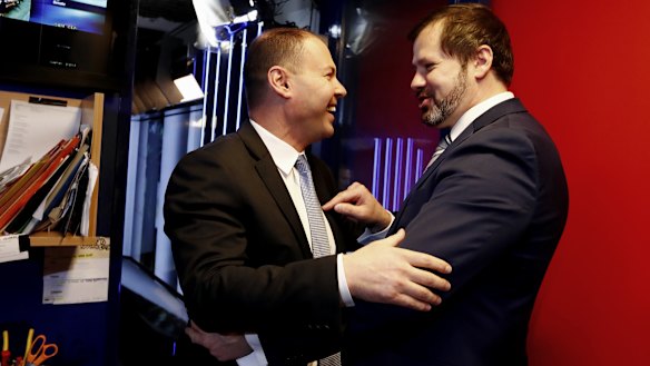 Environment and Energy Minister Josh Frydenberg crosses paths with Labor MP Ed Husic outside the Sky News studio at Parliament House in Canberra in 2017.