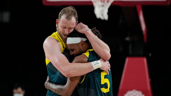 Patty Mills embraces teammate Joe Ingles at the Tokyo 2020 Olympics.