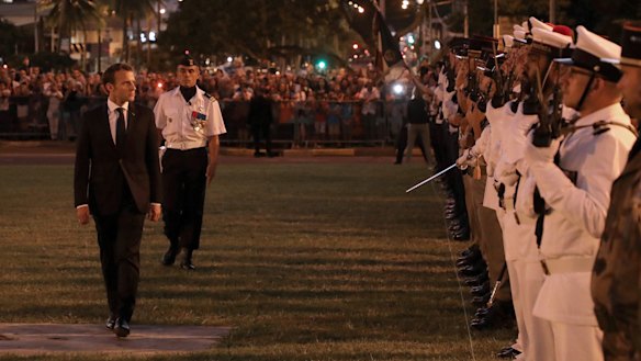 French President Emmanuel Macron reviews an honour guard during a welcoming ceremony at The Coutumier Senate in Noumea on Thursday.