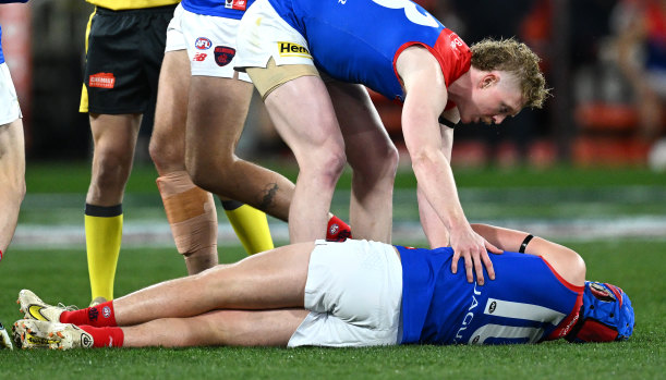 Concerned teammate Clayton Oliver checks on Melbourne’s Angus Brayshaw after he was knocked out after clashing with Collingwood’s Brayden Maynard last week.