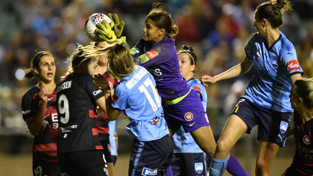 Congested: Wanderers goalkeeper Jada Mathyssen-Whyman gets to the ball ahead of Angelique Hristodoulou.