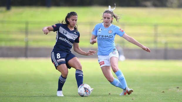Victory's Angela Beard and City's Rhali Dobson play at Epping on Saturday, with the surface having been roundly condemned.