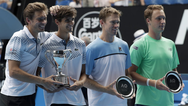 Trophy moment: Players celebrate with silverware after the men's doubles final.
